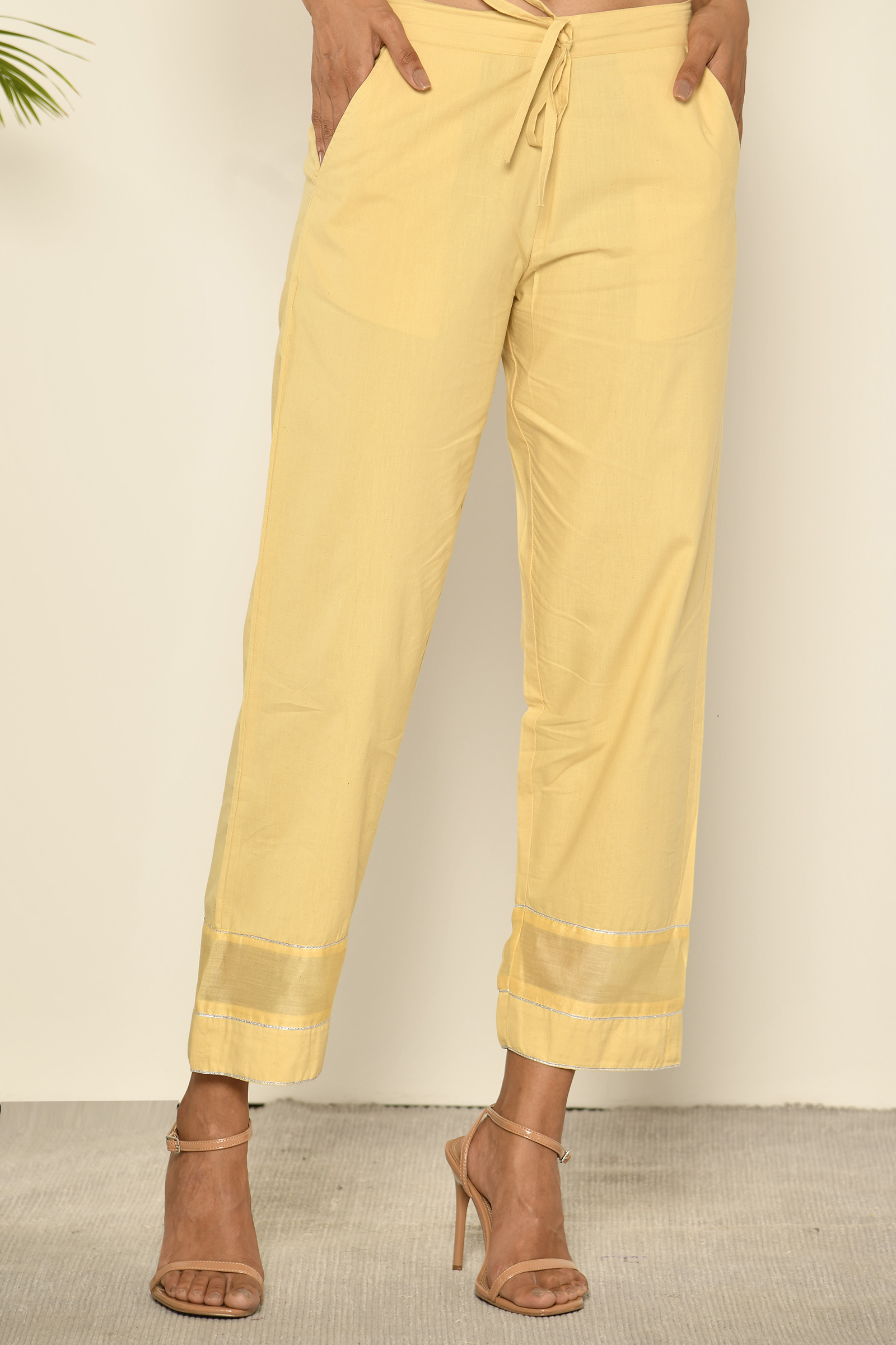 Yellow straight pant with a printed border at hem  Kora India